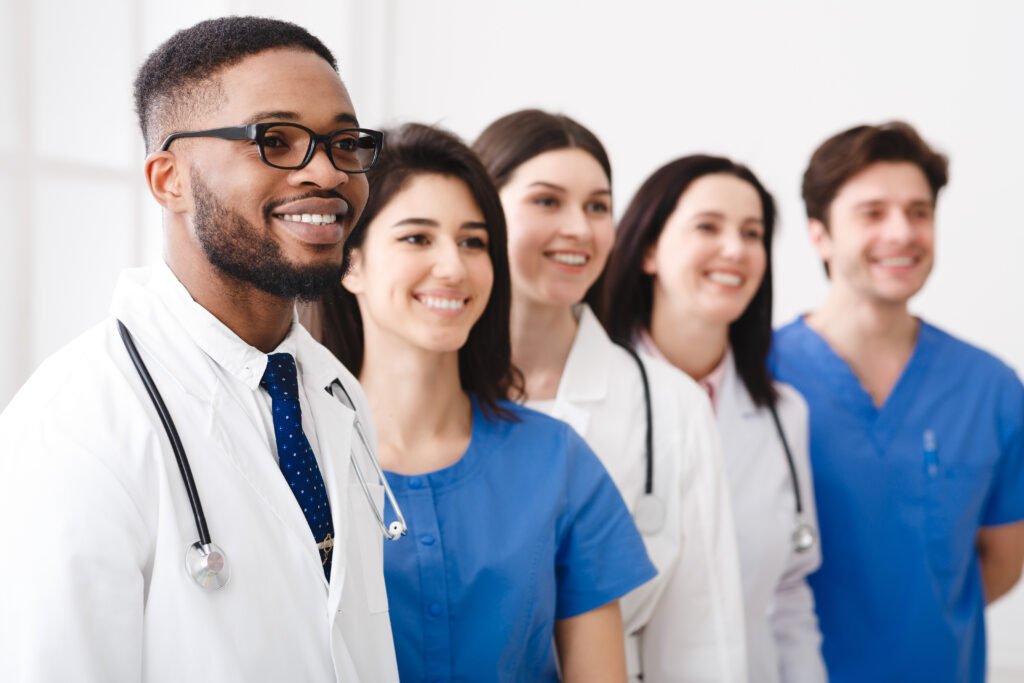 African Doctor Standing In Row With Team